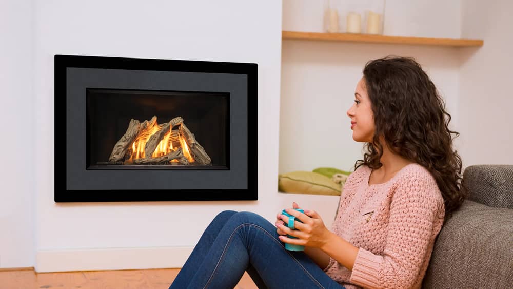 Young girl enjoying a Valor Horizon Gas Fireplace