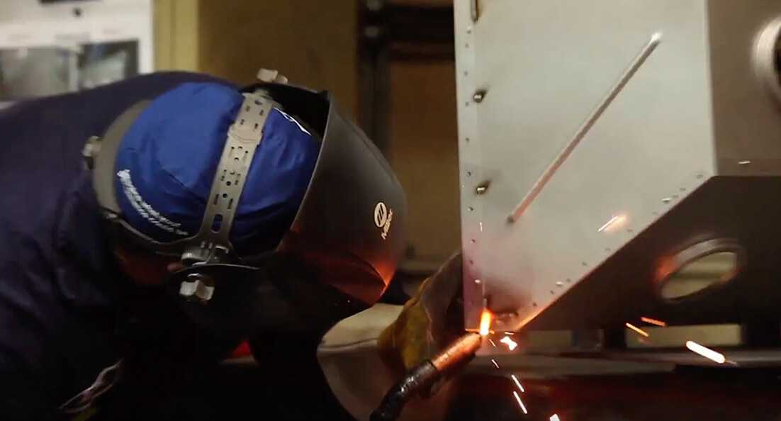 Man Working on Aluminized Steel Valor Firebox